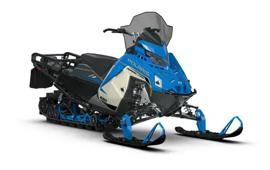 Blue and white Polaris ProStar S4 Voyageur Adventure Ultimate 155 with rear cargo rack